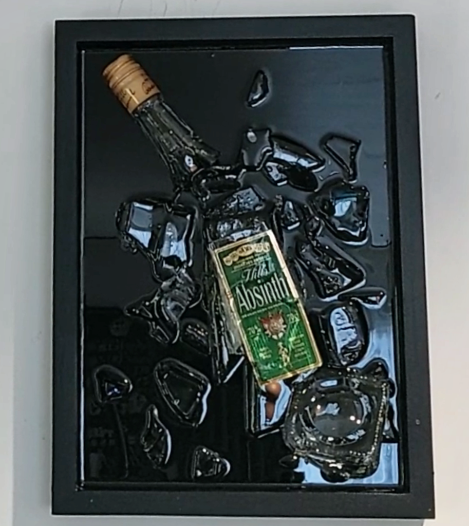 smashed bottle with resin in frame